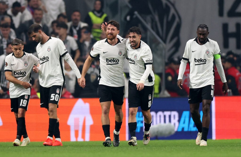 Beşiktaş players in white kits celebrating a goal against Crystal Palace in the Europa League in Istanbul