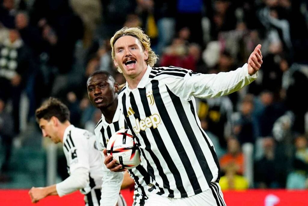 Nick Woltemade holding the ball and celebrating after scoring a penalty for Juventus against Rennes in the Europa League