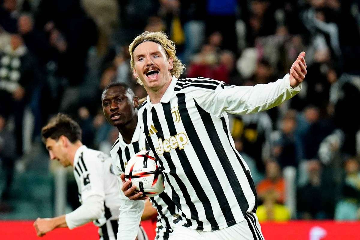 Nick Woltemade holding the ball and celebrating after scoring a penalty for Juventus against Rennes in the Europa League