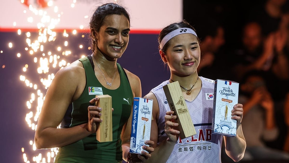 PV Sindhu and An Se-young smile on the podium holding their trophies after the French Open 2026 women's singles final in Paris