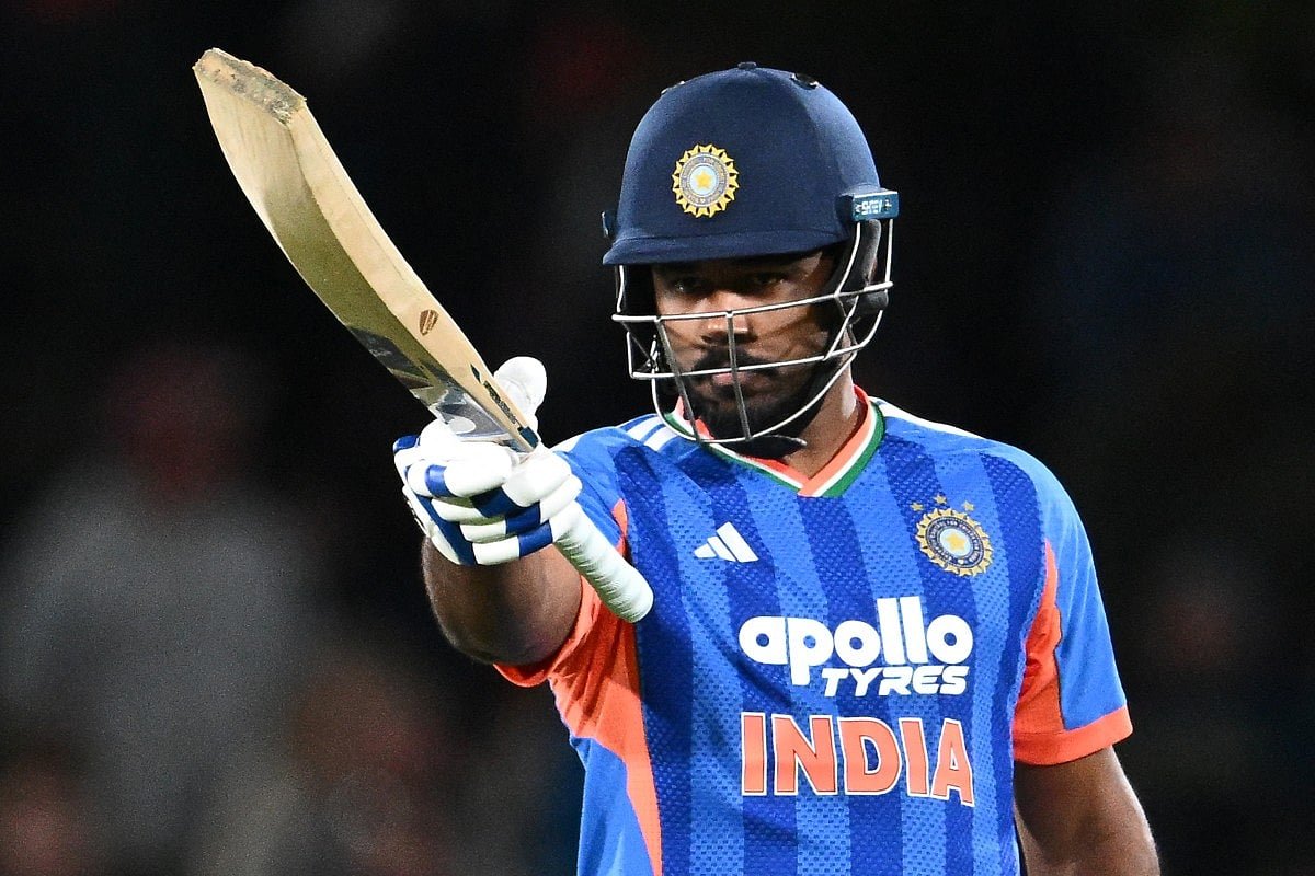 Sanju Samson in India's blue T20I kit and helmet raises his bat after reaching a half-century against New Zealand at Hagley Oval, Christchurch